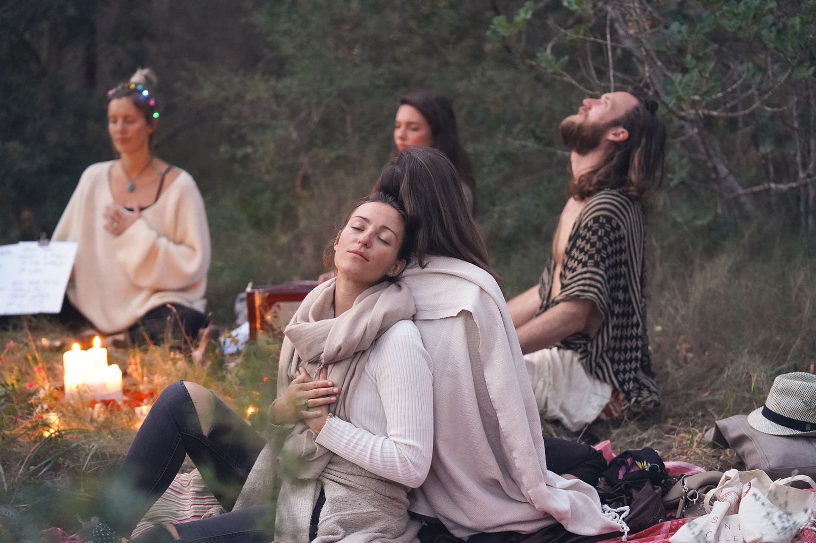 A group in a cacao ceremony circle outdoors
